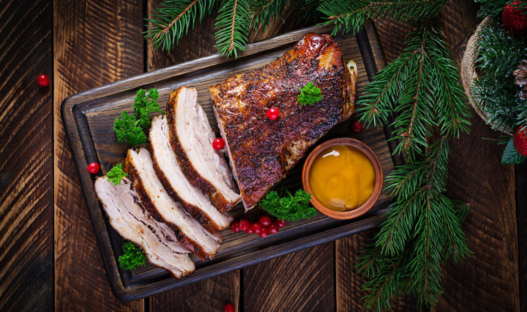 Baked pork belly with herbs. Boiled pork. Festive Christmas table. Top view, overhead