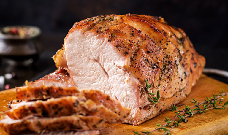 Baked pork belly with herbs. Boiled pork. Festive Christmas table. Top view, overhead